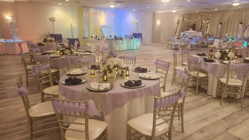 The Grand Ballroom set with round tables and uplighting