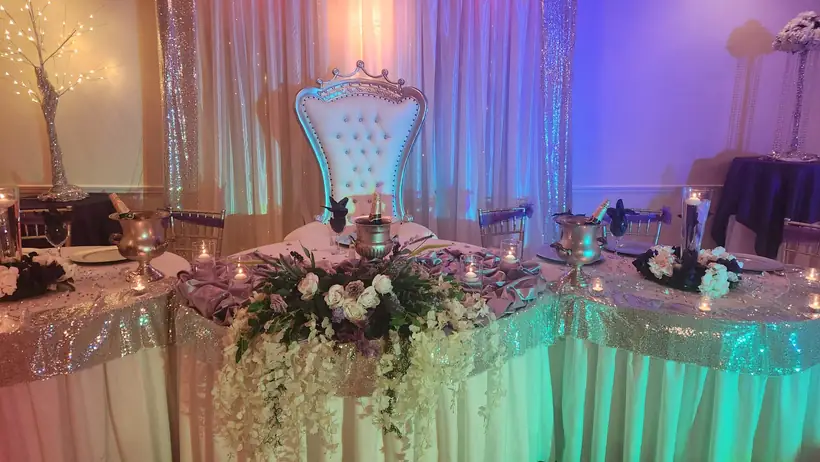Close view of the head table florals and throne chair