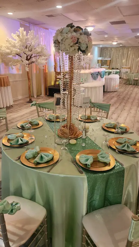 Sage and gold table setting with a floral centerpiece