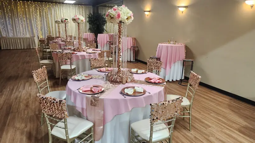 Blush linens and rose gold chairs with tall floral centerpieces